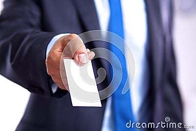 Young businessman holds out his hand with a business card Stock Photo