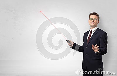 Businessman with laser pointer and copyspace white wall Stock Photo