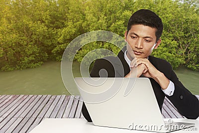 Young businessman looking for a job in the computer monitor Stock Photo