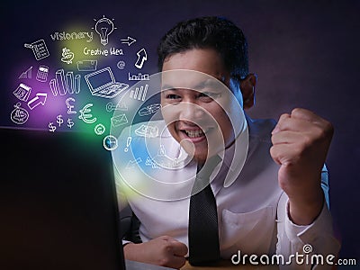 Young Businessman Looking at Laptop, Winning Gesture Stock Photo