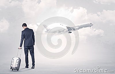 Businessman with luggage walking to airplane Stock Photo
