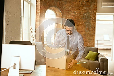 A young businessman moving in office, getting new work place Stock Photo