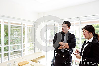 Young businessman in office. Two business professionals working together. Man and woman attractive looking. Stock Photo