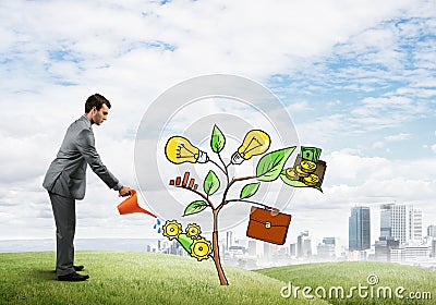 Young businessman outdoors watering drawn growth concept with can Stock Photo