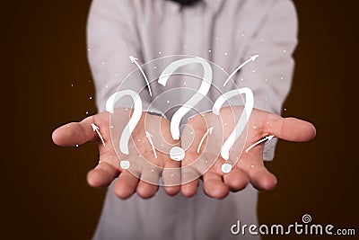 Young businessman presenting hand drawn question marks Stock Photo