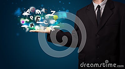Young businessman presenting magical clouds with letters and balloons concept Stock Photo