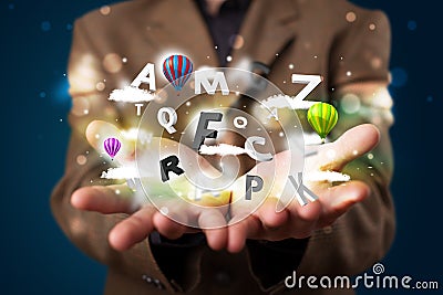 Young businessman presenting magical clouds with letters and balloons concept Stock Photo