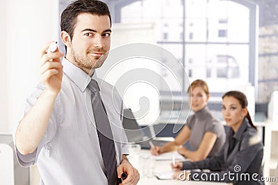 Young businessman presenting smiling Stock Photo