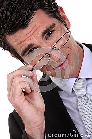 Young businessman removing glasses Stock Photo
