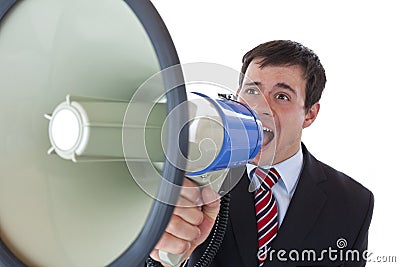 Young businessman shouting loudly into megaphone Stock Photo