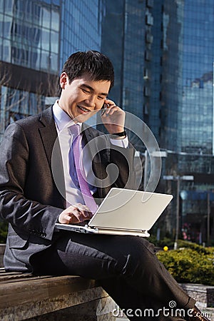 Young businessman sitting with laptop. Stock Photo