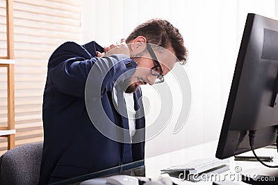 Businessman Suffering From Neckache Stock Photo