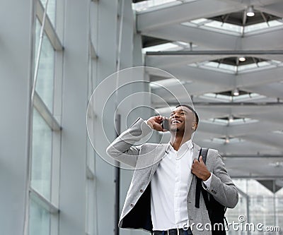 Young businessman smiling and calling by mobile phone Stock Photo