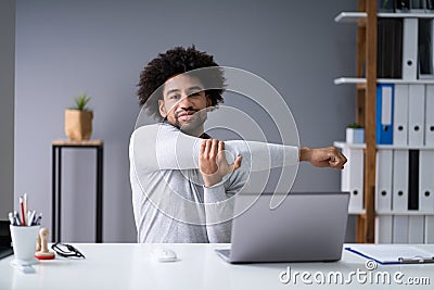 Businessman Stretching His Arms Stock Photo