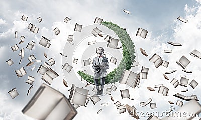 Young businessman or student studying the science and books flying around Stock Photo