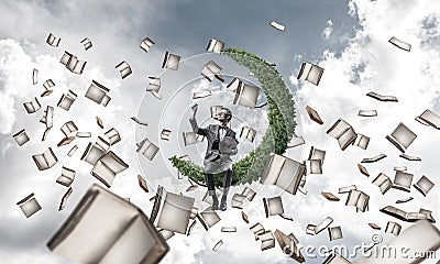 Young businessman or student studying the science and books flying around Stock Photo