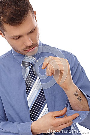 Young businessman with tattoo in forearm Stock Photo