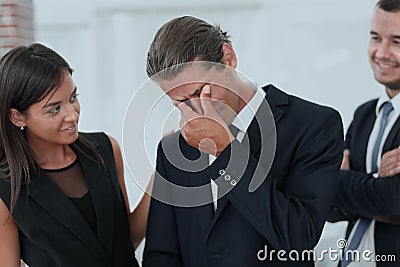 Young businessman with tears of joy and his business team Stock Photo