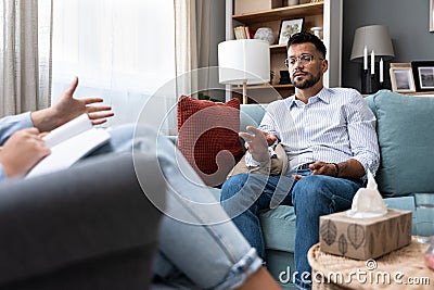Young businessman undergoing psychotherapy after loss of his job, bankruptcy of private company or the death of a close family Stock Photo