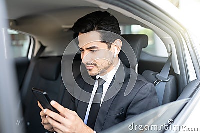 Young Businessman Using Smartphone In Car Stock Photo