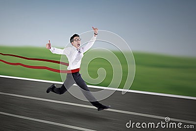 Young businessman winning a business race Stock Photo