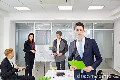 Young businessman working on background of colleagues in the off Stock Photo