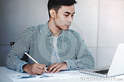 Young Businessman Working on Computer Laptop in Office Stock Photo