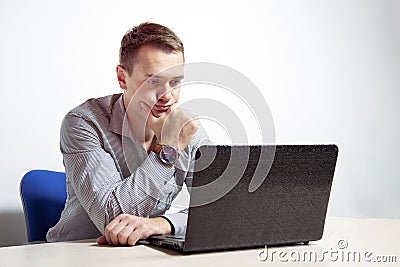 Young businessman working on laptop in office, being concerned Stock Photo
