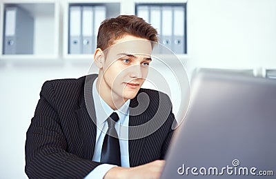 Young businessman working on laptop in office Stock Photo