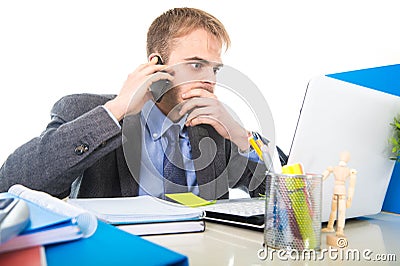 Young businessman worried tired talking on mobile phone in office suffering stress Stock Photo