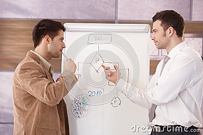 Young businessmen presenting together Stock Photo