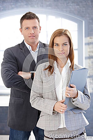 Young businesspeople standing in office Stock Photo