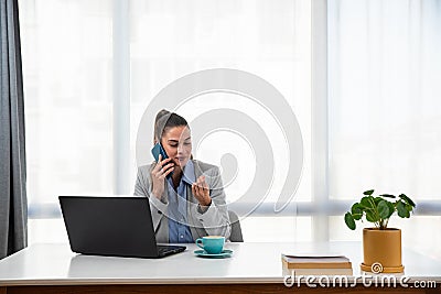 Young businesswoman adjusting to her new workplace after being promoted to a better position in a new office in a global business Stock Photo