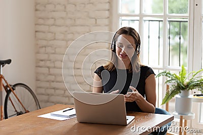 Young businesswoman discussing project details with clients via video call. Stock Photo