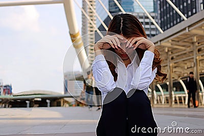 Young businesswoman feeling failure and frustrated with her work. Stressed business concept. Selective focus and shallow depth of Stock Photo