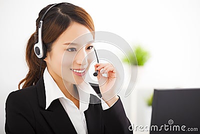 Young businesswoman with headset in office Stock Photo