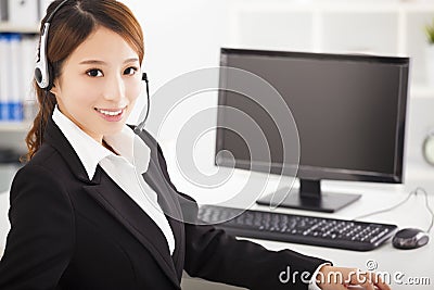 Young businesswoman with headset in office Stock Photo