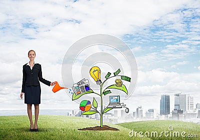 Young businesswoman outdoors watering drawn growth concept with can Stock Photo