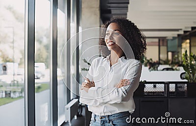 Young businesswoman portrait, Self confident young woman with crossed arms at office, People candid portraits Stock Photo