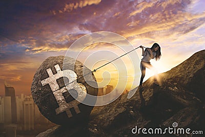 Young businesswoman pulling bitcoin symbol Stock Photo