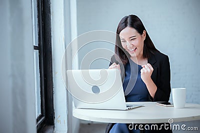 Young businesswoman rejoicing after sales surpass their target Check results from laptop Stock Photo