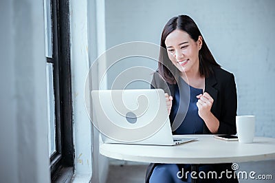 Young businesswoman rejoicing after sales surpass their target Check results from laptop Stock Photo