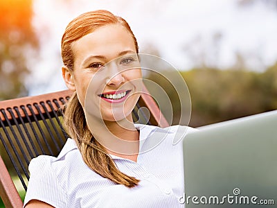 Young businesswoman relaxing during her break in park Stock Photo