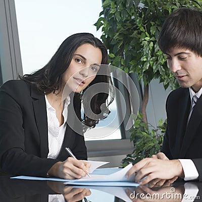 Young businesswoman signing some papers Stock Photo