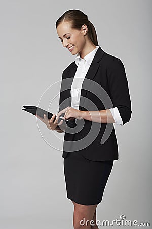 Young businesswoman in studio using tablet Stock Photo