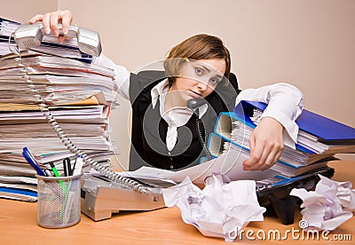 Young businesswoman with tons of documents Stock Photo