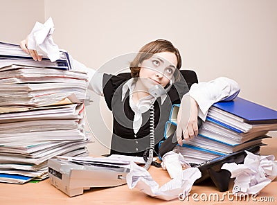 Young businesswoman with tons of documents Stock Photo