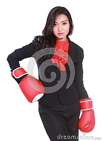 Young businesswoman using boxing gloves Stock Photo