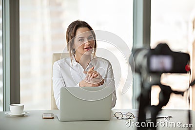 Young businesswoman vlogger recording vlog talking to camera in Stock Photo