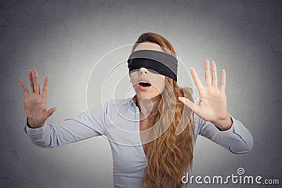 Young businesswoman walking blindfolded with hands forward Stock Photo